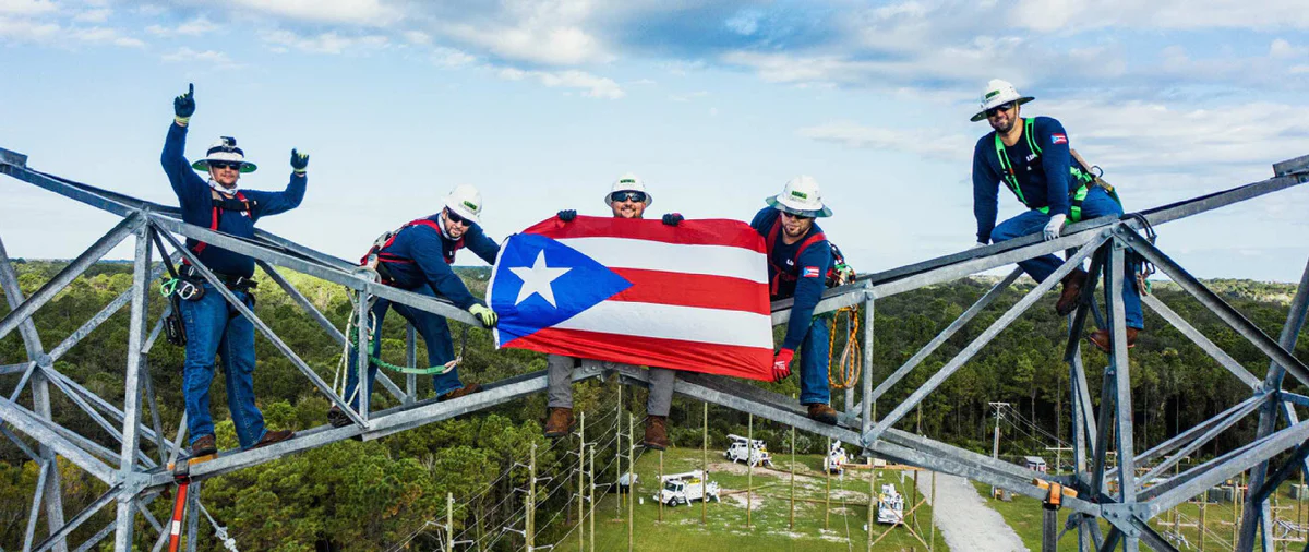 LUMA employees holding flag