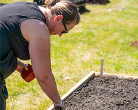 Winner Stephanie planting her garden